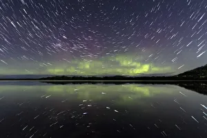 Star trails and the Aurora Australis or Southern Lights reflected in water Star trails and the Aurora Australis or Southern Lights reflected in water