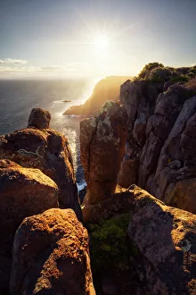 Sunlight lighting up the Tasman Peninsula from Cape Raoul, Tasman National Park, Tasmania Sunlight lighting up the Tasman Peninsula from Cape Raoul, Tasman National Park, Tasmania