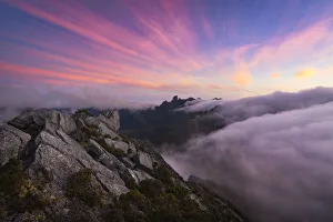 Sunset and fog flow over Federation Peak and the Eastern Arthur Range from the summit of Sunset and fog flow over Federation Peak and the Eastern Arthur Range from the summit of