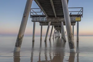 Water flowing under a jetty at Sunrise in Hervey Bay Water flowing under a jetty at Sunrise in Hervey Bay