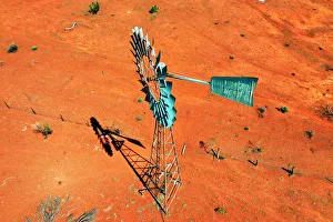 Windmill, water windpump on farm with dry red dirt field, Australia, aerial view Windmill, water windpump on farm with dry red dirt field, Australia, aerial view