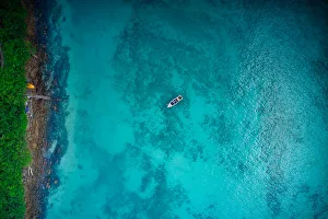 Aerial view of boat on crystal clear water in Phi Phi Island, Krabi, Thailand Aerial view of boat on crystal clear water in Phi Phi Island, Krabi, Thailand