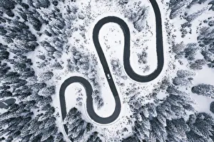 Aerial view of winding road in winter forest Aerial view of winding road in winter forest