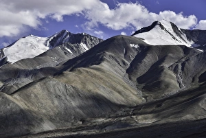 Amazing scenic view of high mountain road in rugged rock covered with melting snow Amazing scenic view of high mountain road in rugged rock covered with melting snow