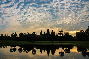 Angkor Wat temple at sunrise reflecting in water Angkor Wat temple at sunrise reflecting in water
