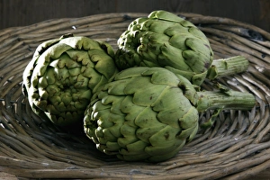 Three artichokes -Cynara cardunculus- in a basket Three artichokes -Cynara cardunculus- in a basket