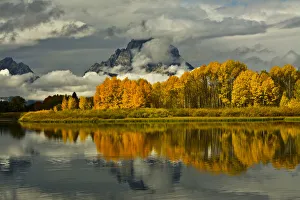 Autumn forest and Mount Moran reflecting in Oxbow Bend of Snake River at Grand Teton Autumn forest and Mount Moran reflecting in Oxbow Bend of Snake River at Grand Teton