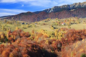 Autumn landscape of hills and mountain range in background, Piatra Craiului National Park Autumn landscape of hills and mountain range in background, Piatra Craiului National Park