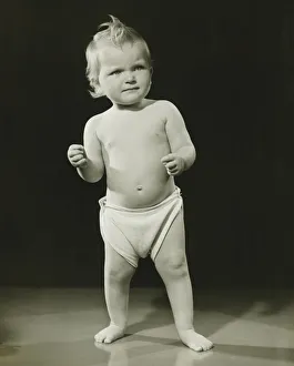 Baby (12-15 months) in diaper standing in studio, (B&W) Baby (12-15 months) in diaper standing in studio, (B&W)