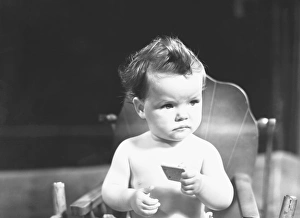 Baby (9-12 months) sitting in high chair, (B&W) Baby (9-12 months) sitting in high chair, (B&W)