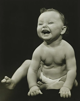 Baby boy (12-18 months) smiling, (B&W), close-up Baby boy (12-18 months) smiling, (B&W), close-up