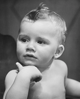Baby boy (9-12 months) looking on side (B&W) Baby boy (9-12 months) looking on side (B&W)