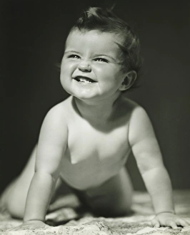 Baby girl (6-9 months) crawling on blanket in studio, (B&W) Baby girl (6-9 months) crawling on blanket in studio, (B&W)