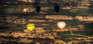 Two balloons floating over Cappadocia landscape Two balloons floating over Cappadocia landscape