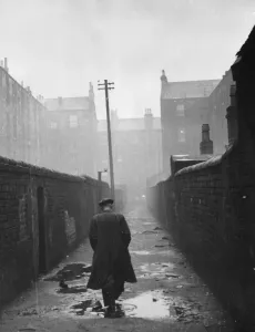 Glasgow Prints: A man walks down a narrow Glasgow backstreet, 1948 print