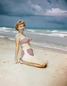 Vintage Beachwear Prints: Model Wearing Red and White Bikini on Beach