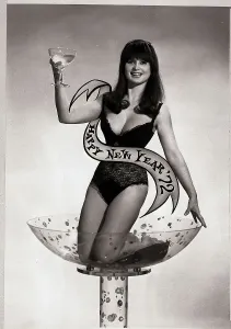 Prints of (Original Caption) 12/31/1971-New York, NY-: If you've got to lift a glass to the New Year, you could do a lot worse than having it filled with the likes of Austrian showgirl Rita Atlanta Rita Prints: Rita Atlanta in Large Cocktail Glass Print 12/31/1971