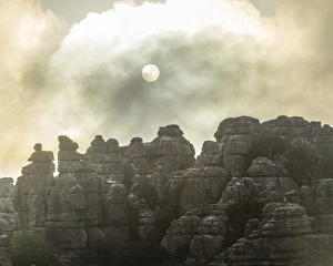 Bizarre limestone rock formations with the sun and fog, El Torcal Nature Reserve Bizarre limestone rock formations with the sun and fog, El Torcal Nature Reserve