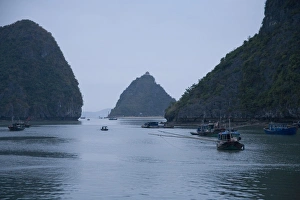 Boats and islands at dusk on Vietnamese bay Boats and islands at dusk on Vietnamese bay