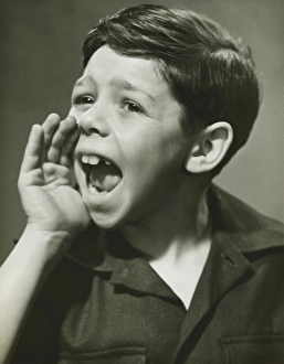 Boy (8-9) yelling in studio, (B&W), portrait Boy (8-9) yelling in studio, (B&W), portrait