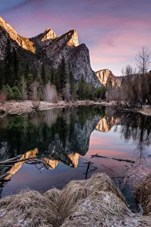 Three Brothers Mountain in Yosemite National Park at Sunrise Reflected in the Merced Three Brothers Mountain in Yosemite National Park at Sunrise Reflected in the Merced