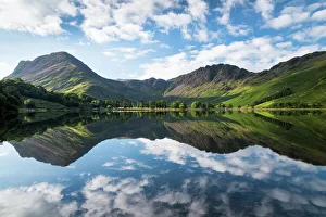 Buttermere lake early morning reflections. A beautiful summer morning with Fleetwith Pike Buttermere lake early morning reflections. A beautiful summer morning with Fleetwith Pike