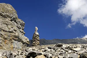 Cairn as signpost and orientation help in rocky alpine terrain without trails, Valais Cairn as signpost and orientation help in rocky alpine terrain without trails, Valais