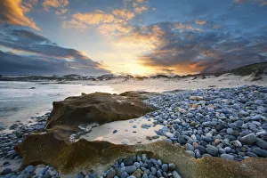 Clouds at sunset over a sand and pebble beach - Arniston South Africa Clouds at sunset over a sand and pebble beach - Arniston South Africa