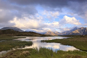 Cloudy sky at Jaufenpass, Passo di Monte Giovo, mountain lake, evening mood, Sterzing Cloudy sky at Jaufenpass, Passo di Monte Giovo, mountain lake, evening mood, Sterzing