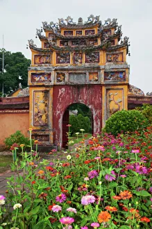 Colorful gate with flowers inside the Hue Citadel Colorful gate with flowers inside the Hue Citadel