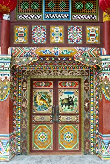 Colorful Tibetan designs on wall and door panels of temple, Jiuzhaigou National Scenic Area, Sichuan Province, China Colorful Tibetan designs on wall and door panels of temple, Jiuzhaigou National Scenic Area, Sichuan Province, China