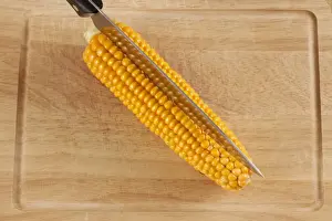 Vegetable Nutrition Images Prints: Corn or maize cob with kitchen knife