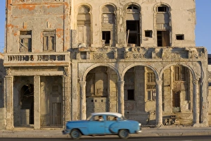 Cuba, Havana, blue car passing building on street Cuba, Havana, blue car passing building on street