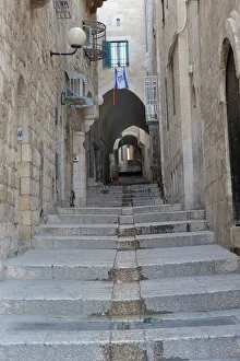 Deserted alleyway with Israeli flag hanging from a window above an archway, Muslim Quarter, Old City, Jerusalem Deserted alleyway with Israeli flag hanging from a window above an archway, Muslim Quarter, Old City, Jerusalem