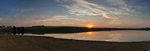 Dramatic panoramic sunset landscape photo over a peaceful remote and isolated farm lake Dramatic panoramic sunset landscape photo over a peaceful remote and isolated farm lake