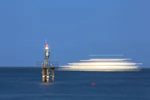Evening mood with a with moving ship at the Hoernle Lighthouse, Lake Constance, Konstanz Evening mood with a with moving ship at the Hoernle Lighthouse, Lake Constance, Konstanz