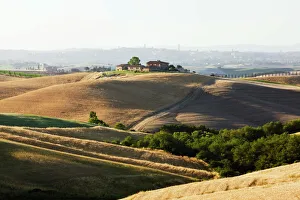 Farmhouse on a hill, typical Tuscan landscape near Ville de Corsano, Tuscany, Italy Farmhouse on a hill, typical Tuscan landscape near Ville de Corsano, Tuscany, Italy