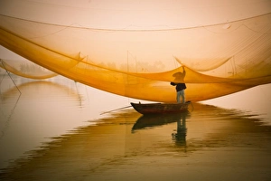 fisher man check his nets in early morning on river fisher man check his nets in early morning on river