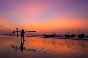 Fisherman going on the beach at dawn in Vietnam Fisherman going on the beach at dawn in Vietnam