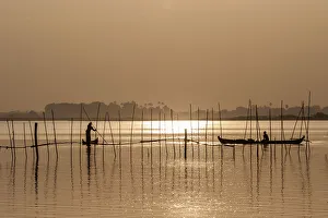 Fishermen in boats in the evening light, Taungthaman Lake, Mandalay, Myanmar Fishermen in boats in the evening light, Taungthaman Lake, Mandalay, Myanmar