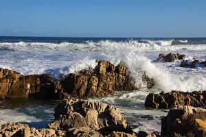 Foamy waves roll over rugged rocks off the point at the popular holiday resort of Buffalo Foamy waves roll over rugged rocks off the point at the popular holiday resort of Buffalo