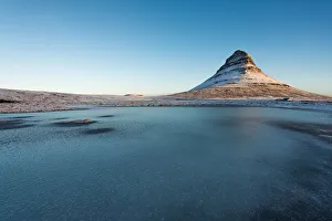 The frozen lake and Mt. Kirkjufell, Iceland The frozen lake and Mt. Kirkjufell, Iceland