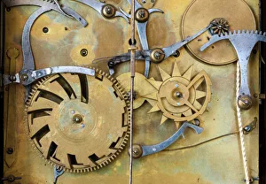 Gears and cogs in the clockwork of a historical pendulum clock, detail, regulator Gears and cogs in the clockwork of a historical pendulum clock, detail, regulator