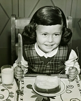 Girl (4-5) having meal, holding fork and knife, (B&W) Girl (4-5) having meal, holding fork and knife, (B&W)