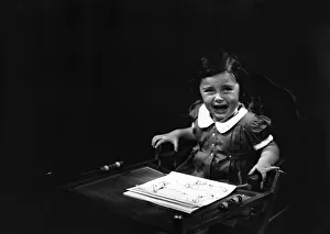 Girl (4-5) sitting in high chair, crying, (B&W) Girl (4-5) sitting in high chair, crying, (B&W)
