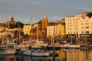 Golden early morning light shines on St Peter Port Golden early morning light shines on St Peter Port