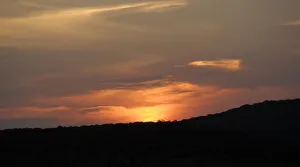 Golden sunset falling behind silhouetted hills in the Phinda Private Game Reserve Golden sunset falling behind silhouetted hills in the Phinda Private Game Reserve
