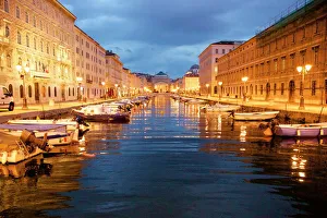 Grand canal with boats at night in Trieste, Italy Grand canal with boats at night in Trieste, Italy