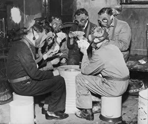 Images Dated 30th August 2005: Group of men playing cards, wearing gas masks (B&W)