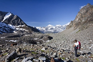 Hiker during ascent of Mt Tschenglser Hochwand above Duesseldorfer Huette hut in Sulden, Mt Vertainspitze Hiker during ascent of Mt Tschenglser Hochwand above Duesseldorfer Huette hut in Sulden, Mt Vertainspitze